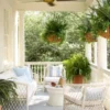 Serena & Lily covered front porch decor idea with haint blue ceiling and hanging flower baskets