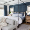 Love this beautiful bedroom design with a blue accent wall, black canopy bed, and neutral bench at the end of the bed - bedroom ideas - master bedroom - bedroom decorating ideas - coastal bedroom - salt design
