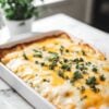 The best creamy stacked chicken enchilada recipe with green sauce, sour cream, tortillas, and lots of cheese. So quick and easy--perfect for weeknight dinners or feeding a crowd! - Jane at Home