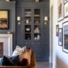 Light-filled living room featuring a curved sofa and warm ambient lighting from brass sconces, showcasing 2026 home décor trends and color palette